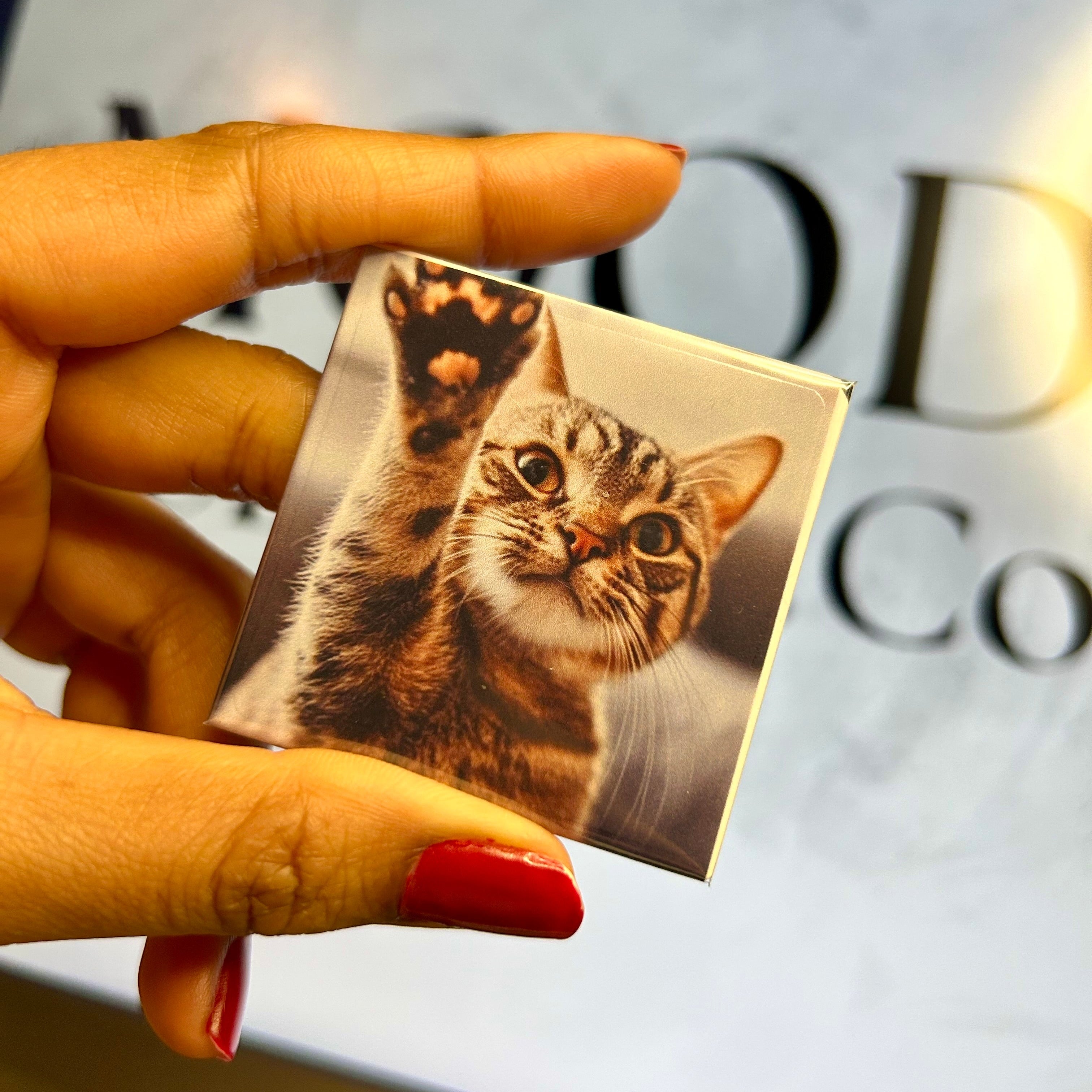 Close-up of the glossy metallic finish on a high-quality custom photo magnet.