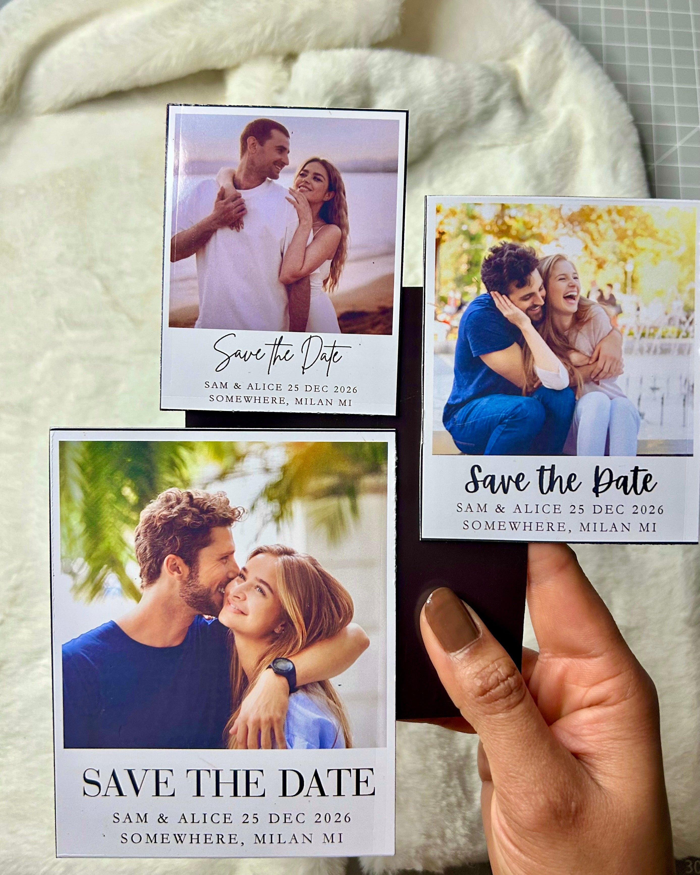 Save the date photo magnets held in hand to show size and scale