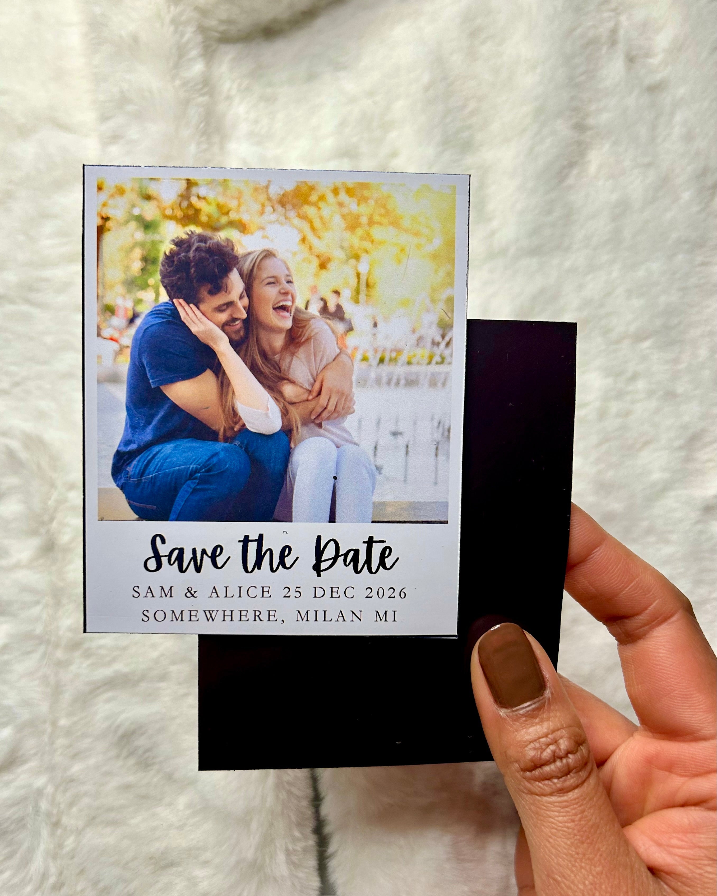 3.25 x 4-inch save the date photo magnet held in hand to show size and scale