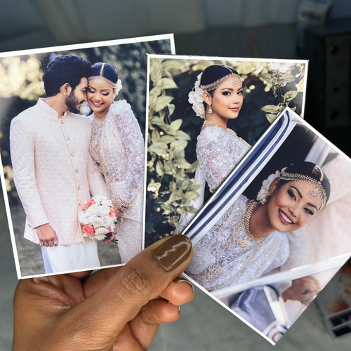 Custom photo magnets held in hand to show size and scale.